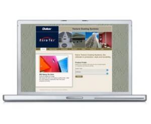 Laptop displaying the home page of the Dulux Acratex website with white Dulux logo on a blue background and a textured pattern in the background