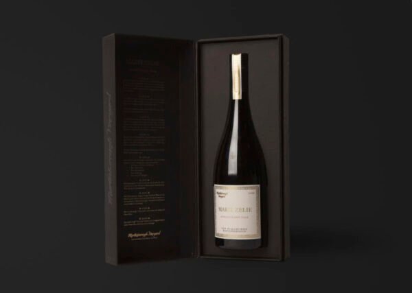 Bottle of wine in elegant black box with text.