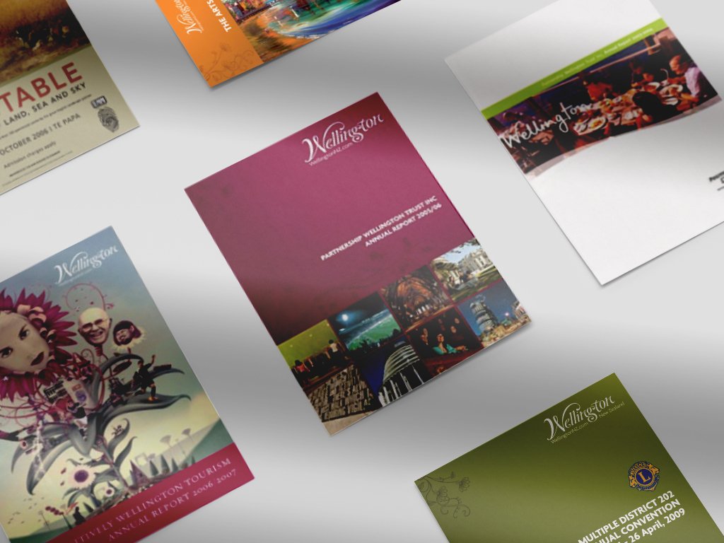 Assorted tourism brochures for Wellington spread out on a table.