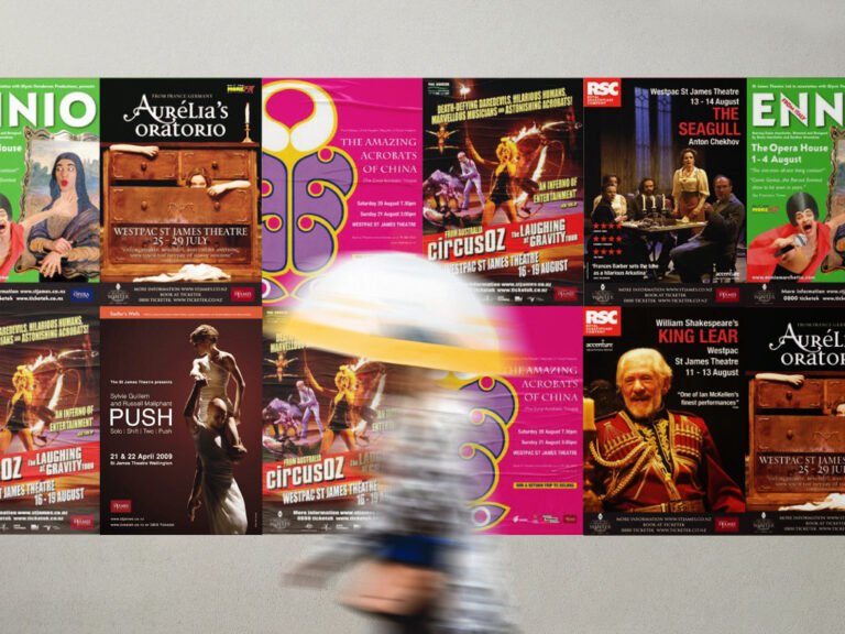 Colourful event posters on a wall, person passing by.